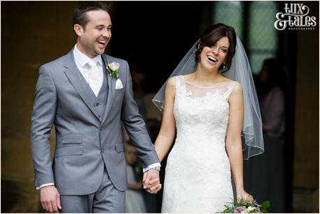 Bride and groom walk out of escrick church smiling