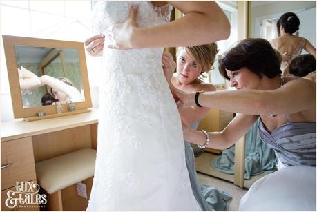 Bride gets into dress york wedding photographer