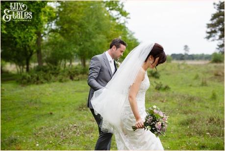 Bride & groom walk into field near york