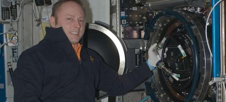 Astronaut Mike Fincke pictured to the left of the Combustion Integrated Rack facility installed in the Destiny module of the ISS shortly after installation