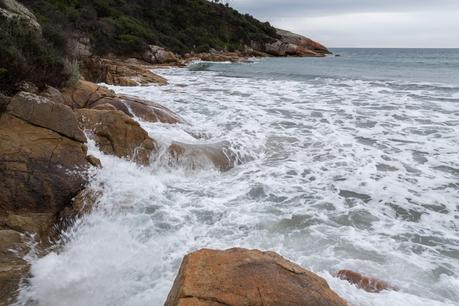 high tide against rocks lighthouse point wilsons promontory