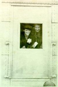 Ava Helen and Linus peeking through a train window, Spring 1938.