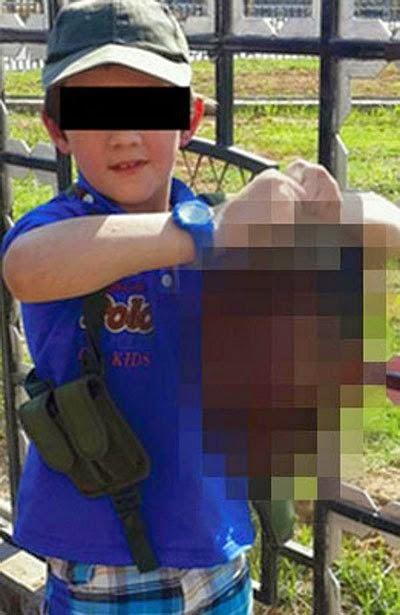 Barbaric Photo Shocks The World! 7 Year Old Holding Severed Head