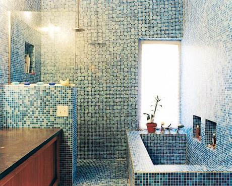 The blue-tiled master bathroom stands in contrast to the muted tones of the rest of the house. The tile is recycled glass from China.