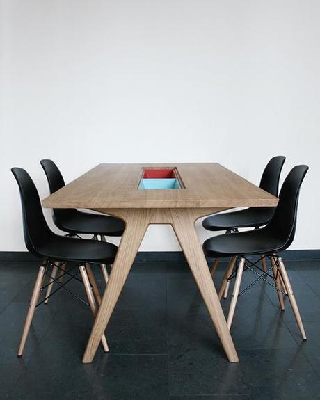 Wooden dining table with storage cases and Eames side chairs