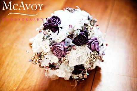 The bridal bouquet made of ribbon roses, buttons, jewels and beads