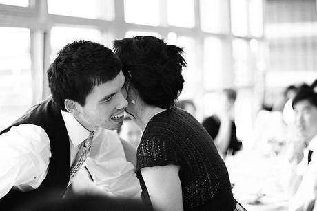 Female guest kissing the groom