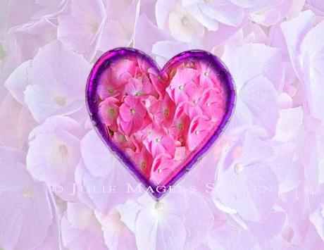 A Valentine card with a heart full of pink flower petals on a pale lavender background of petals.