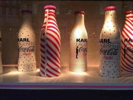 This years, limited edition COCA COLA BOTTLES by KARL LAGERFELD; Every single window of the Printemps dept store was filled with a moving, twirling, dancing display of the new bottles which feature the designers signature silhouette logo.   Xoxo