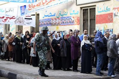 Egyptians wait at a polling station