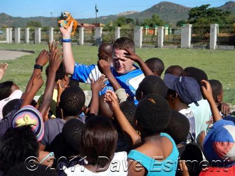 Enduro rider handing toys to children