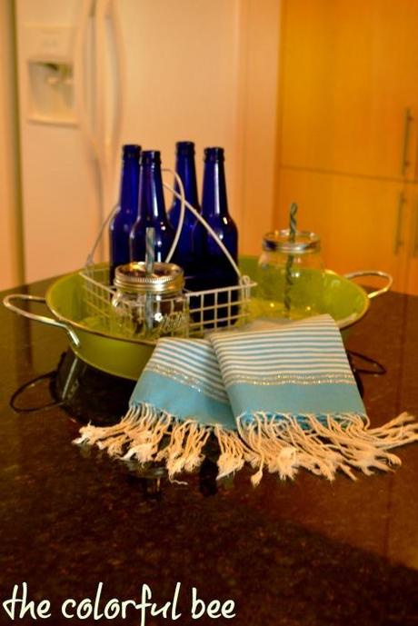 cobalt blue bottles, pale blue kitchen towels and green tray for beachy decoration in kitchen
