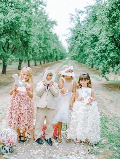 Have flower girls and ring bearer hold LOVE letters