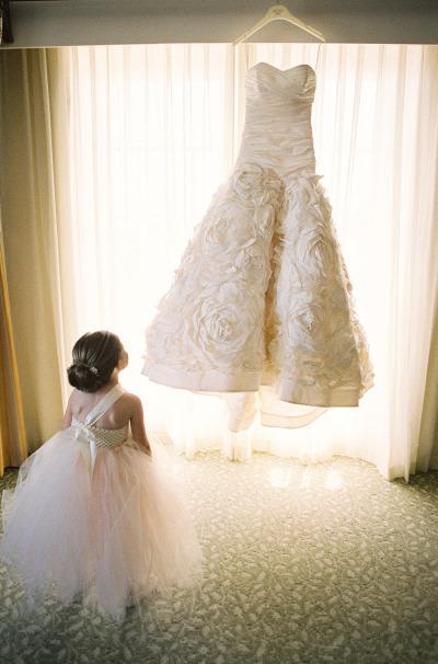 Little Girl in awe of the Wedding Dress