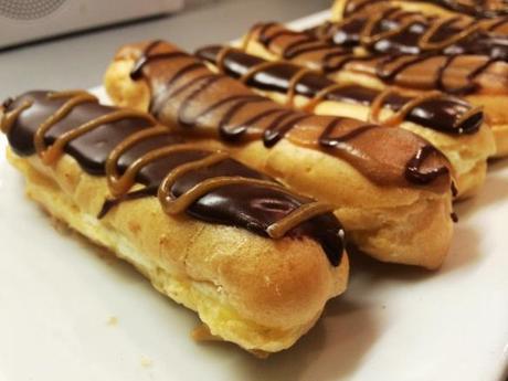 chocolate and caramel cream filled choux pastry eclairs piped icing finish