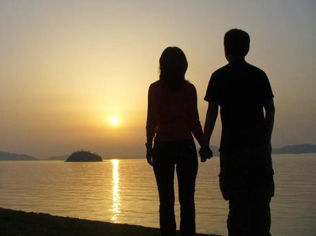 couple holding hands in sunset