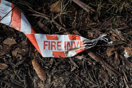 fire investigation tape lying in forest