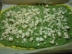 Greek Omelette Roll with Spinach Spreading filling over omelet that has been baked until set