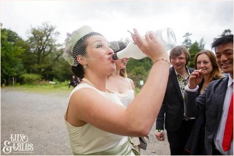 Lake District Wedding Photographer | Derwentwater Youth Hostel Wedding | Alternative eclectic wedding styling | Tux & Tales Photography | Party | Bride drinks rum from bottle