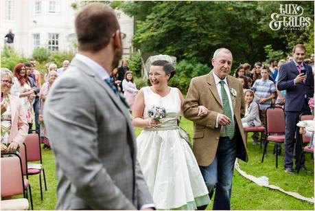 Lake District Wedding Photographer | Derwentwater Youth Hostel Wedding | Alternative eclectic wedding styling | Tux & Tales Photography | Ceremony | bride walks up aisle at outdoor wedding