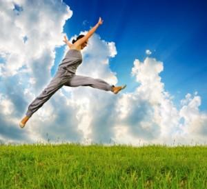 young sporty woman runing and jumping on meadow