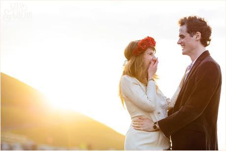 Photography Engagement Shoot in Whitby | Girl wearing Red Flower crown | Alterntive Couple whereing Vintage clothing | Laughing in the sunset
