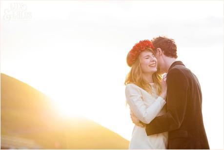 Photography Engagement Shoot in Whitby | Girl wearing Red Flower crown | Alterntive Couple whereing Vintage clothing | Hugging and cuddling in the sunset