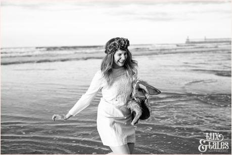 Photography Engagement Shoot in Whitby | Girl wearing Red Flower crown | Alterntive Couple whereing Vintage clothing | Running through the ocean water holding shoes