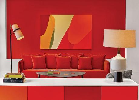 Manhattan hotel room with orange and red walls and sofa