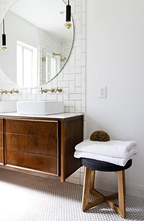 There's a couple of things I like about this room: large round mirror; the vintage wall hung vanity echoes the journey to all of the modern interpretations we see today, but is one of a kind - and those timber tones in a bathroom - sensational.