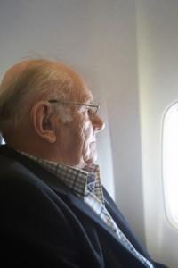 Man looking outside plane window