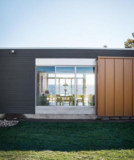ontario vacation home facade made of wood siding and aluminum with floor to ceiling windows