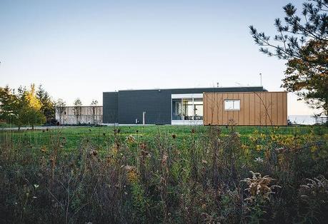 ontario vacation home facade made of wood siding and aluminum with floor to ceiling windows