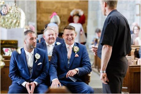 Leeds church wedding photography groom laughing and talking to vicar