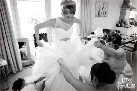 The Priory Cottages Wedding Photography Bride preparation fluffing dress