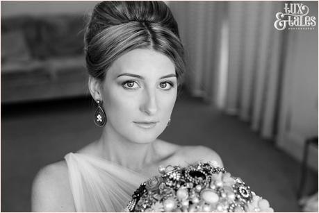 The Priory Cottages Wedding Photography Bride preparation portrait holding brooch bouquet