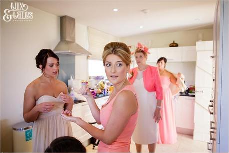 The Priory Cottages Wedding Photography Bride preparation surrounded by bridesmaids