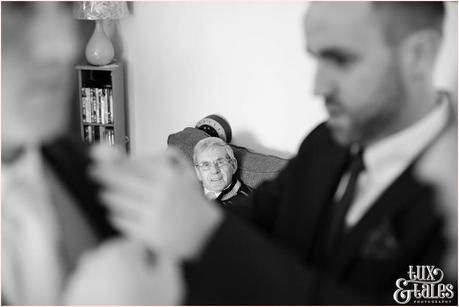 The Priory Cottages Wedding Photography Groom preparation father watching buttonholes