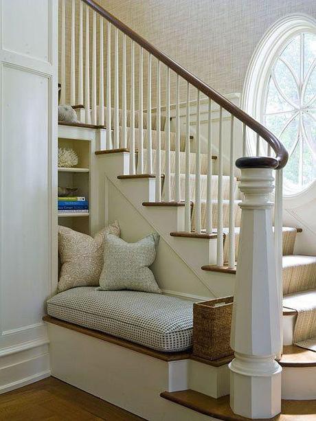 From Chic Coastal Living, a welcoming bench and place to pull off shoes at the base of a foyer staircase.