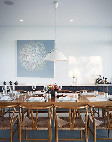 ontario vacation home with cloud white dining area with custom table and carl hansen & søn pendant lamp