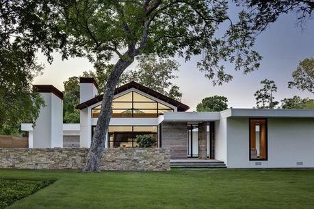 Renovated ranch home with limestone walls and gabled Cor-Ten roof