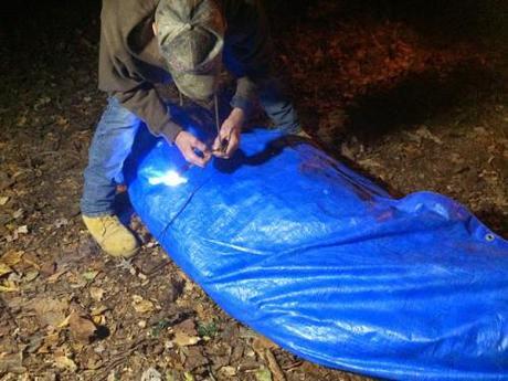 Dyer tying the Sasquatch in the tarp.