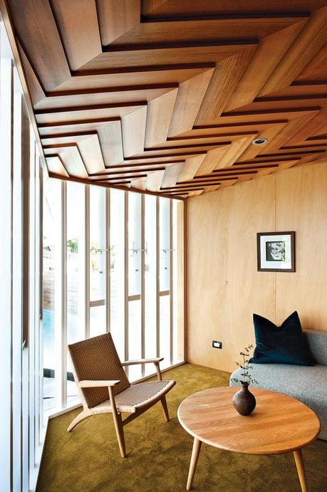 Modern lounge area with mullioned windows and Hans J. Wegner chairs