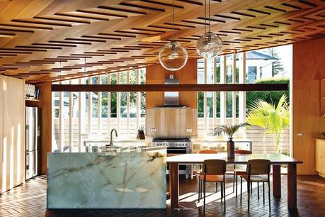 Modern dining room with wooden herringbone patterned ceiling