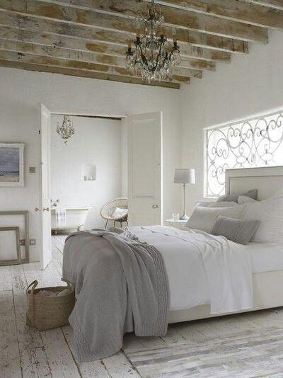 I love the exposed beams and the chandelier with the neutral palette and furnishings - very White Company
