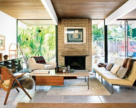 Living room featuring a travertine-topped coffee table by Paul McCobb pairs well 
with the Florence Knoll Parallel Bar System sofa. The Josef Albers print over the fireplace is an original, scored on eBay.