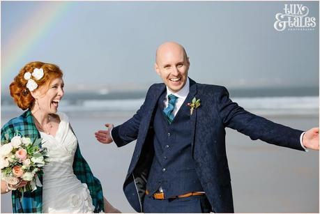 Bride & Groom Portraits in the rain at Newton Hall beachside wedding photography | Smiling in the rainbow