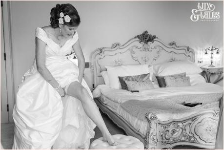 Bride Preparation Photography at Newton Hall beachside wedding | Putting on Garter