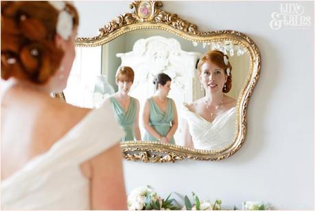 Bride Preparation Photography at Newton Hall beachside wedding | Bride looks in mirror