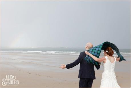 Bride & Groom Portraits in the rain at Newton Hall beachside wedding photography | Rainbow